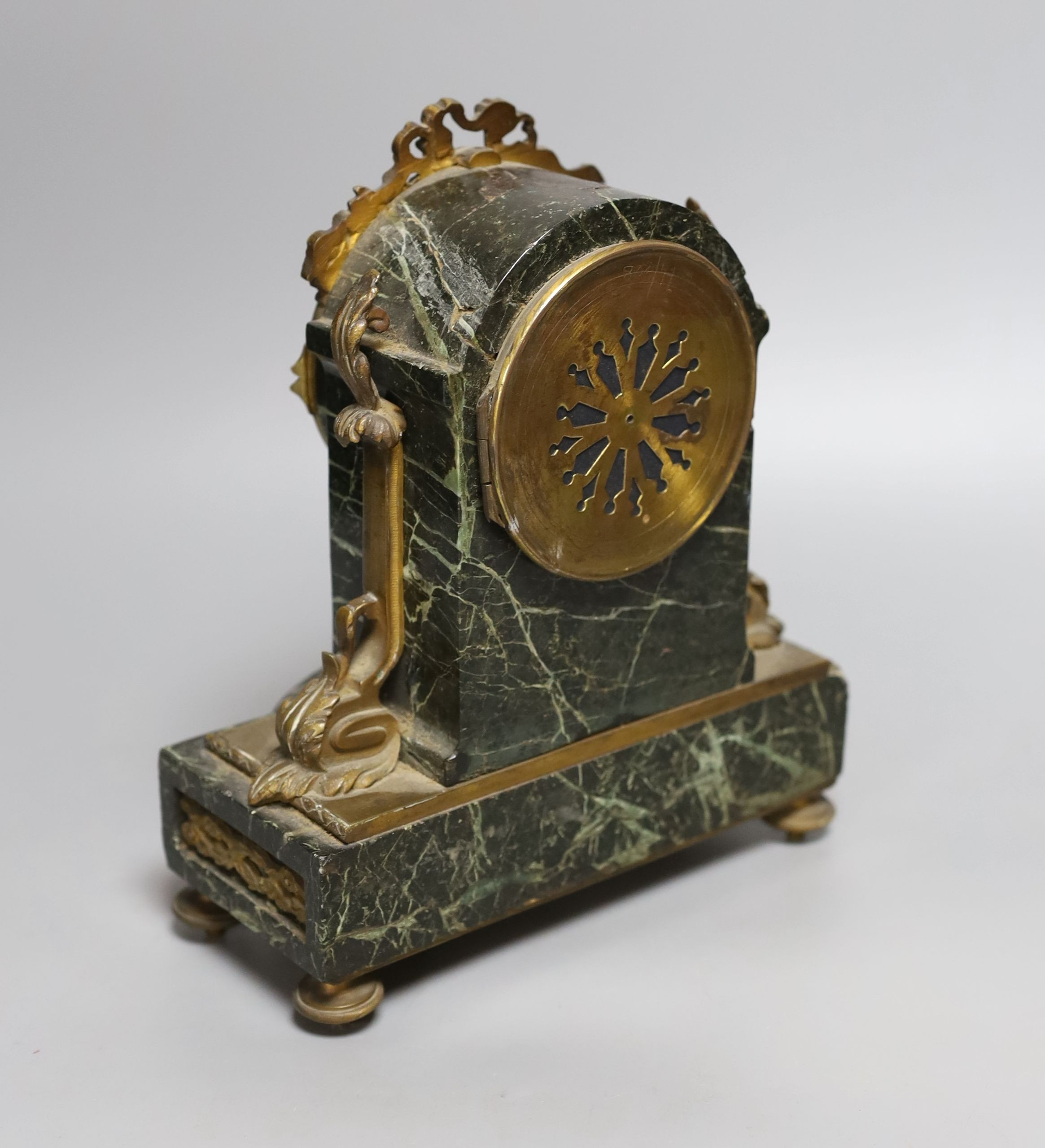 A 19th century French gilt metal mounted serpentine mantel clock, 23cms high.